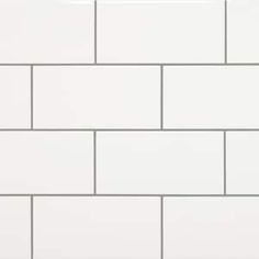 a white brick wall with grey grouting