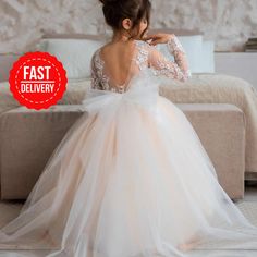 PERFECT FLOWER GIRL DRESS✨ Make order today and SAVE 15%🎁delivery 3-4 days only! Beautiful Baby Flower girl dress with lace embroidery and amazing puffy skirt! Process time: 1-2 working days Delivery time: 2-4 working days  Also offer express overnight delivery https://www.etsy.com/listing/1298332912/express-delivery?click_key=eb8207bd8376c2fa762384c4d5701f79c6bcbc77%3A1298332912&click_sum=63123b47&ga_search_query=express&ref=shop_items_search_1&frs=1 *Train is detachable & all dresses have bow White Lace Bodice Tutu Dress For Bridesmaid, Cream Tulle Tutu Dress For Bridesmaids, White Tutu Dress For Wedding, Cream Tulle Tutu Bridesmaid Dress, White Princess Dress With Tulle Skirt For Bridesmaid, Cream Tulle Bridesmaid Tutu Dress, Long Sleeve Tulle Pageant Dress For Wedding, Cream Tulle Skirt Dress For First Communion, Princess Style Cream Dress With Tulle Skirt