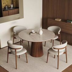 a dining table with four chairs around it