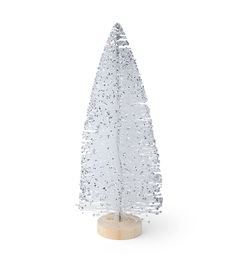 a plastic christmas tree on a wooden stand with snow flakes all over the top