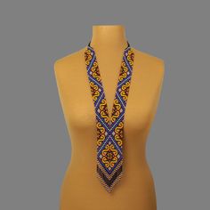 "A yellow and blue necklace is a stylish and original jewelry. A seed bead necklace will make you more tender and sophisticated. An elegant necklace will be a wonderful birthday gift for your wife. Despite the size, the bead necklace is light.  A long necklace is a versatile accessory that can complement any outfit, regardless of style. All handmade jewelry in our assortment is unique. Each product has its style and original design. Nevertheless, many jewelry pieces are easily combined, creating an unforgettable image. ------------------ The hippie jewelry is one of the best gift ideas. At SweetBeadsIP, you will find a gift for everyone - a gift for a girlfriend, a gift for a mother, a gift for a sister, or a gift for a daughter. The necklace is made of colorful Czech beads carefully threa Elegant Yellow Long Beaded Necklaces, Elegant Yellow Long Beaded Necklace, Elegant Long Yellow Beaded Necklace, Traditional Blue Beaded Necklace For Gift, Elegant Yellow Jewelry With Tiny Beads, Elegant Yellow Beaded Chain, Handmade Yellow Beaded Necklaces For Gifts, Handmade Yellow Beaded Necklaces As Gift, Blue Long Beaded Necklace With Tiny Beads