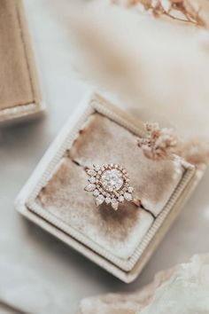 an engagement ring sitting on top of a box