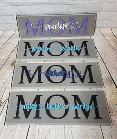 three metal signs that say mom and baby