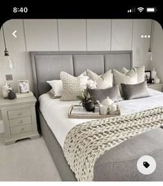 a bed with many pillows on top of it