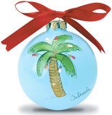 a blue ornament with a palm tree on it and a red ribbon hanging from the top