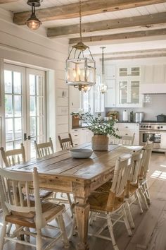 a wooden table with chairs around it in a kitchen