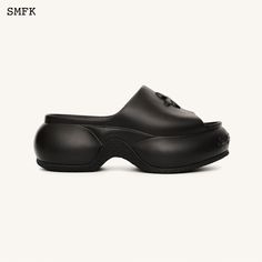 a pair of black clogs on top of a white background with the word smf