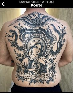 the back of a woman's tattoo with an image of mary and two snakes