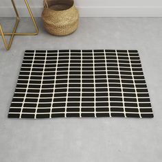 a rug on the floor with a basket next to it