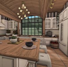 a large kitchen with wooden floors and white cabinets in the center is surrounded by windows