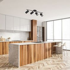 an empty kitchen with wooden cabinets and white counter tops, along with two bar stools