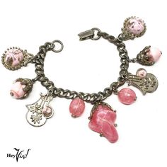 Vintage 50s Chunky Charm Bracelet with Pink Baubles and Beads 7" Long - Hey Viv This vintage bracelet gives you lots to look at and admire. It has marbleized pink beads, shield style pieces with flowers, and a chunky piece of shaped pink plastic.  * Material: silver tone metal - notice the fancy pieces that hold in the beads.  * Closure: fold over clip  * Measurements: 7" from end to end. Largest charm is 1 1/4" long, shields are 1" long  * Condition: very good - the chunky pink piece has some wear on the edges. Vintage Bracelets from Hey Viv ! are lovely to wear. Each one is unique and comes in a sheer organza Gift Bag. Pick up one as a gift or a treat for yourself. "Vintage Charm for your Modern Style" at Hey Viv ! 19-0819-09 Thanks for stopping by :) and shopping at a Small US Based Bus Vintage Dangle Charm Bracelet, Vintage Large Beads Jewelry, Vintage Pink Bracelets With Round Beads, Vintage Metal Jewelry With Polished Beads, Vintage Polished Metal Bead Jewelry, Vintage Pink Metal Bracelets, Vintage Dangle Jewelry With Large Beads, Pink Vintage Charm Metal Jewelry, Retro Beaded Dangle Jewelry