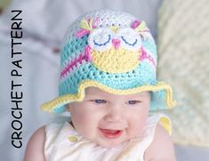 a smiling baby wearing a crocheted hat