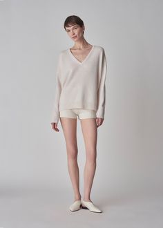 A relaxed v-neck sweater in boiled cashmere with rib trim. Details Ivory boiled cashmere sweater Deep v-neckline Relaxed fit Rib trim at neck, cuffs, and hem 100% Cashmere 7291CMR-ESSN Designed for a relaxed fit. Size down for a slimmer fit. Model is 5'11" and wears a size Small. Cream Cashmere Sweater, Neck Cream, Exclusive Dress, Silk Knit, Silk Yarn, Ribbed Texture, Cotton Viscose, Cashmere Sweater, V Neck Sweater