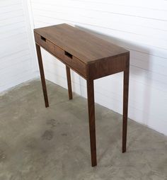 a small wooden table with two drawers on the top and one drawer at the bottom