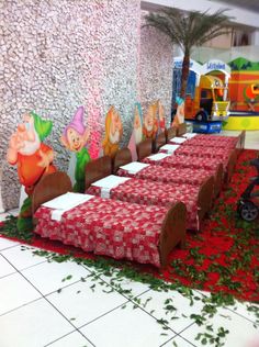 there is a long table set up with red and white cloths on the floor