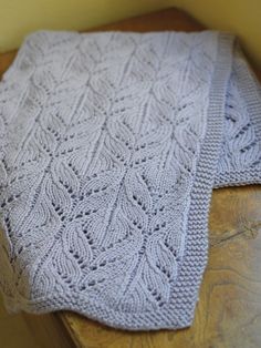 a white blanket sitting on top of a wooden table