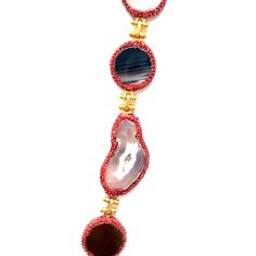 This exquisite necklace showcases a harmonious blend of vibrant gemstones, each radiating its unique charm. The centerpiece is a striking large blue stone, perfectly complemented by an array of smaller multicolored stones, all set in delicate gold settings. Ideal for adding a pop of color and elegance to any outfit. Luxury Multicolor Multi-stone Necklaces, Luxury Multicolor Natural Gemstones, Luxury Multicolor Necklace With Gemstone Accents, Luxury Multicolor Gemstone Necklaces, Luxury Multicolor Necklaces With Natural Stones, Luxury Multicolor Necklaces With Gemstone Accents, Luxury Multicolor Natural Stone Necklaces, Luxury Multicolor Natural Stone Necklace, Luxury Multicolor Gemstones