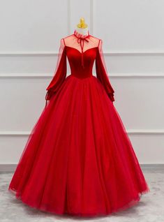 Imbued with regal elegance, this prom dress is a treasure trove of design details that create a narrative of sophistication. The alluring high neckline with lace overlay sets a tone of aristocratic grace, inviting onlookers to a dance of the eyes towards the sheer, full-length sleeves that whisper of a bygone era's charm. The heart-shaped lining beneath the translucent fabric provides a tasteful allure, while the expansive skirt, adorned with glimmering sequins scattered across the tulle, offers a spectacular display of opulence. This dress does more than drape; it hugs the form in a loving embrace, enhancing the silhouette and empowering the wearer with an air of undeniable majesty. Perfect for the prom-goer who desires to embody a story of elegance, this gown promises to weave an enchant Sailor Galaxia, Prom Dress Long Sleeve, Prom Dress Long, Tulle Sleeves, Floor Length Prom Dresses, Long Sleeve Prom, Beautiful Prom Dresses, Red Prom, Prom Dresses With Sleeves