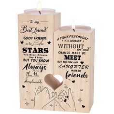 two wooden candles with words on them and a heart shaped candle holder in the middle