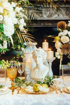 the table is set with candles, flowers and fruit for an elegant wedding breakfasteon