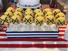 a table topped with cake pops covered in yellow frosting and crossed crosses on them