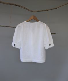 "Classic white and black women V-neck button down blouse, easy to be layered with camisole as a shirt or by itself as a blouse. The puffy sleeves are very flattering; pair it with pants, jeans or skirts for a chic and young look. - Prewashed medium weight linen (180g) - Relaxed fit - Button down opening - Elbow-length puffed sleeves with cuff and button - Can be tucked or untucked Please provide your shoulder width, full bust measurement ( measured around the fullest part) and your height in the Summer V-neck Blouse With Button Cuffs, Summer V-neck Tops With Button Cuffs, White Short Sleeve Top With Button Cuffs, Summer V-neck Blouse With Rolled Sleeves, Summer Puff Sleeve Tops With Button Cuffs, White Half Sleeve Blouse With Buttons, V-neck Summer Tops With Button Cuffs, White Half Sleeve Top With Button Closure, Summer V-neck Top With Button Cuffs