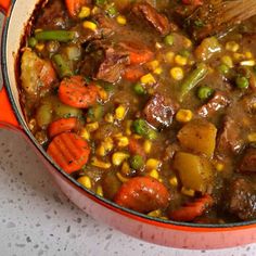 a pot filled with stew and vegetables on top of a table