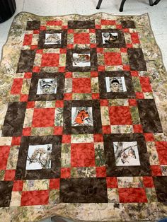 a quilt is laying on the floor in front of a chair with a black and red blanket