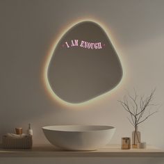 a white bowl sitting on top of a wooden table next to a wall mounted mirror