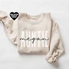 a white sweatshirt with the words, megane written in black ink on it