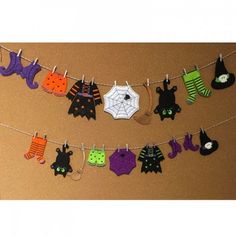 halloween decorations hanging on a clothes line with bats and spider webs in the background