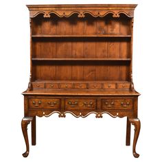 an old wooden bookcase with drawers on the bottom and one drawer at the top