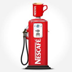 an old fashioned red gas pump with a cup on top