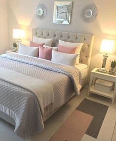 a bedroom with a large bed and two lamps