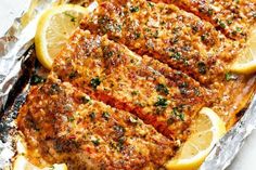 grilled fish with lemons and parsley on foil