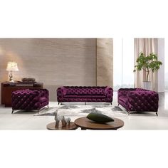 a living room filled with purple couches next to a coffee table and vases