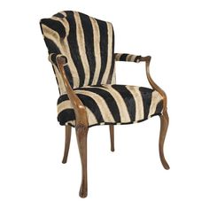 a zebra print upholstered chair with wooden legs and arm rests against a white background