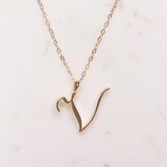 V Initial Necklace - Cursive "V" initial - Initials Necklace for Women - Gold initials necklace - Women's Monogram Necklace - gift for her Dainty "V" initial. Perfect every day necklace. Lovely gift for your self, sister, bridesmaids, new mom. Pendant: Base metal is brass and 14K gold plated. Chain is 18 inches, 14k gold filled.  Note: model shots might show a different initial, only to illustrate overall look and length of the chain. This listing is for the "V" initial. Cursive V, Alphabet Necklace Initials, Letters Cursive, V Initial, Every Day Necklace, Initials Necklace, Gold Initial Pendant, Special Gifts For Her, Jewelry Clothing