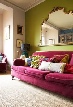 a living room filled with furniture and a large mirror