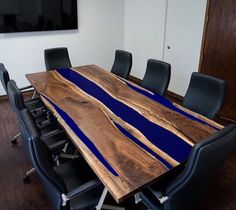 a wooden table with black chairs around it