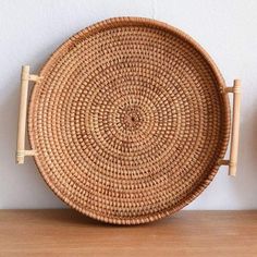 a woven basket sitting on top of a wooden table