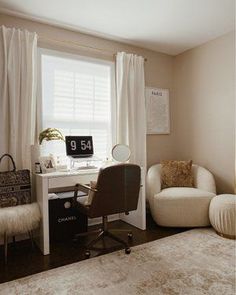 a bedroom with a bed, desk and chair next to a window in the corner