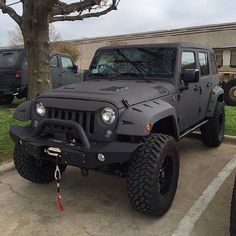 a gray jeep parked in a parking lot