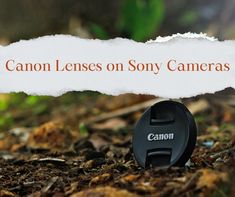 a camera lens cap sitting on the ground next to a sign that says canon lenses on sony cameras