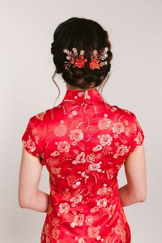 a woman wearing a red dress with flowers in her hair