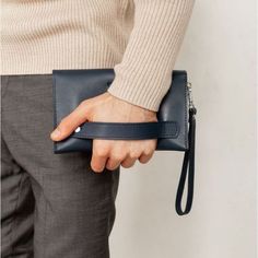 A leather men's clutch is an indispensable item for a modern business man.The accessory is made by hand. Strong genuine leather was used for tailoring.Inside the accessory there are two large compartments and 10 pockets for cards and business cards. There is also a zipper pocket on the front outer wall of the accessory for coins and other small items.The button clutch closes. For convenience, the accessory is equipped with a removable leather loop, which allows you to wear the accessory on the w Men’s Purse, Clutch Bag Outfit, Small Man Bags, Leather Bags For Men, Men Purse, Mens Pouch, Men Clutch Bag, Mens Leather Accessories, Interview Outfits