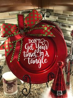 a red plate with green polka dots on it that says don't get your tinsel in a tangle