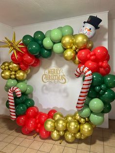 a christmas wreath made out of balloons and candy canes