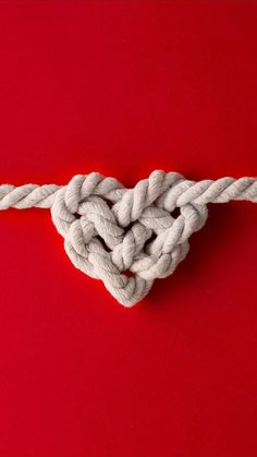 a knot in the shape of a heart on a red background